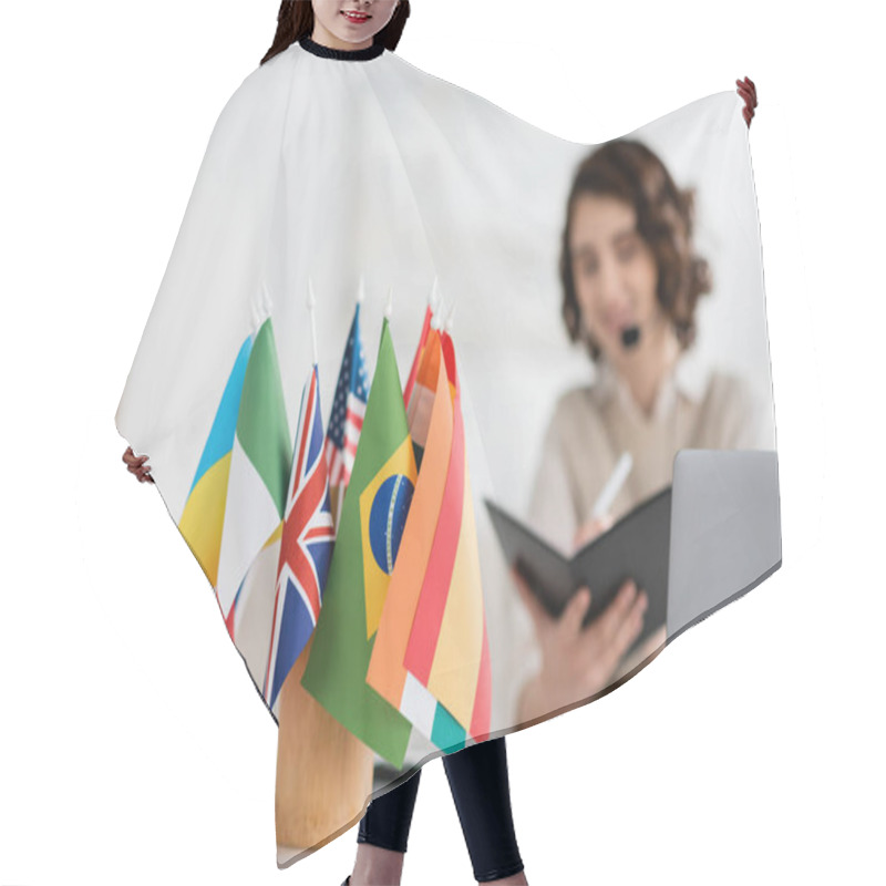 Personality  Selective Focus Of International Flags Near Language Teacher Writing In Notebook During Online Lesson At Home Hair Cutting Cape