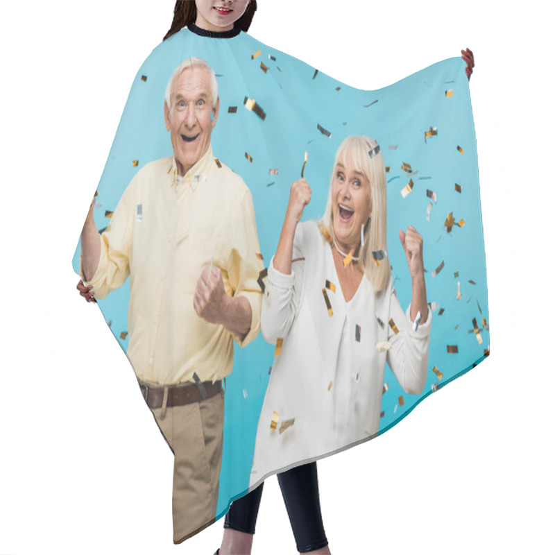 Personality  Happy Retired Husband And Wife Gesturing Near Falling Confetti On Blue  Hair Cutting Cape