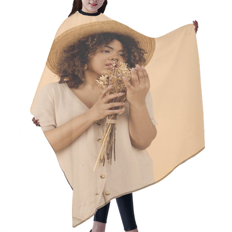 Personality  A Young African American Woman With Curly Hair Wearing A Straw Hat, Holding A Vibrant Bunch Of Flowers In A Studio Setting. Hair Cutting Cape