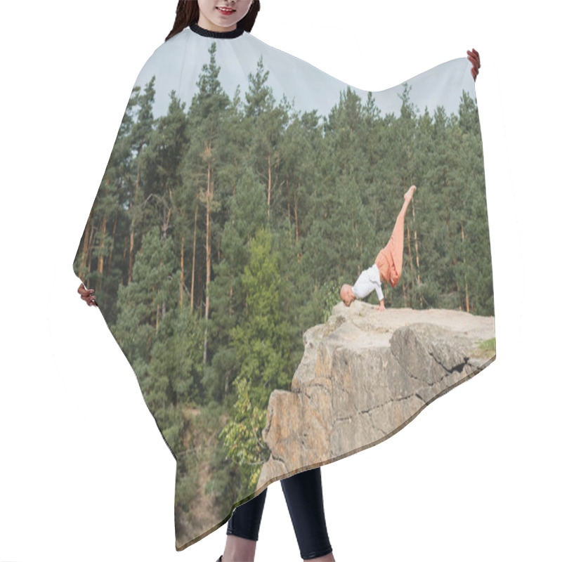 Personality  Side View Of Buddhist Practicing Arm Balancing Pose On High Rocky Cliff In Forest Hair Cutting Cape