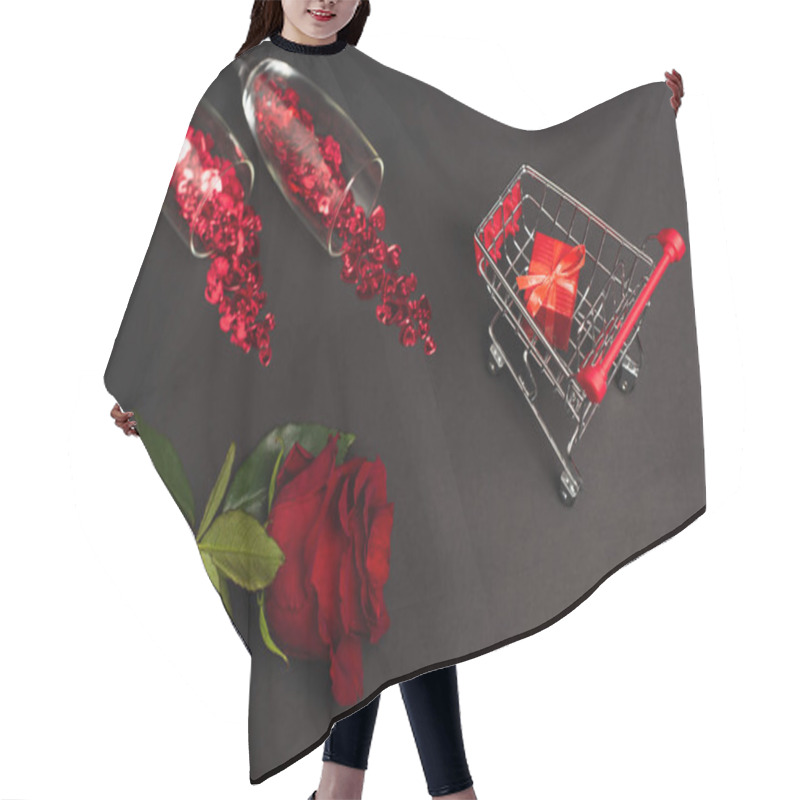 Personality  Top View Of Red Rose Near Glasses With Confetti And Tiny Present In Shopping Cart On Black Hair Cutting Cape