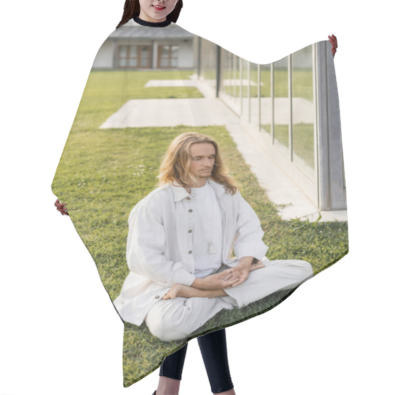 Personality  Full Length Of Long Haired Man In White Clothes Practicing Yoga In Lotus Pose While Sitting On Lawn Near House Hair Cutting Cape