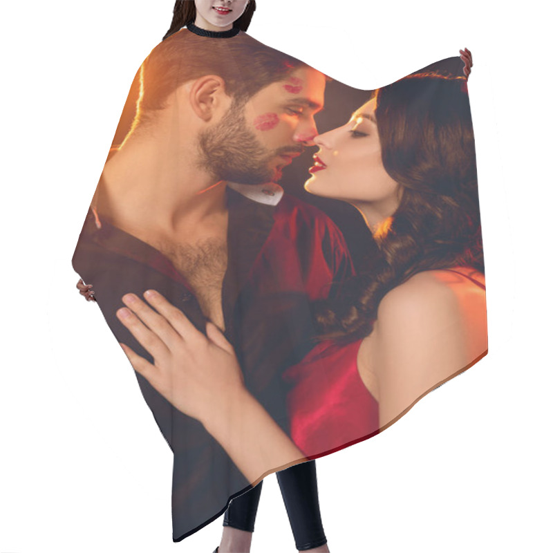 Personality  Beautiful Woman Kissing Handsome Boyfriend With Lipstick Prints On Face On Black Background With Lighting Hair Cutting Cape