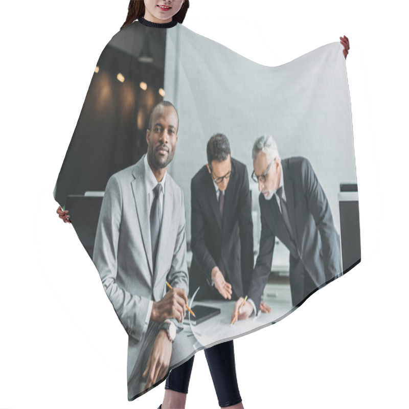 Personality  African American Businessman Looking At Camera While Business Colleagues Discussing Work In Office Hair Cutting Cape