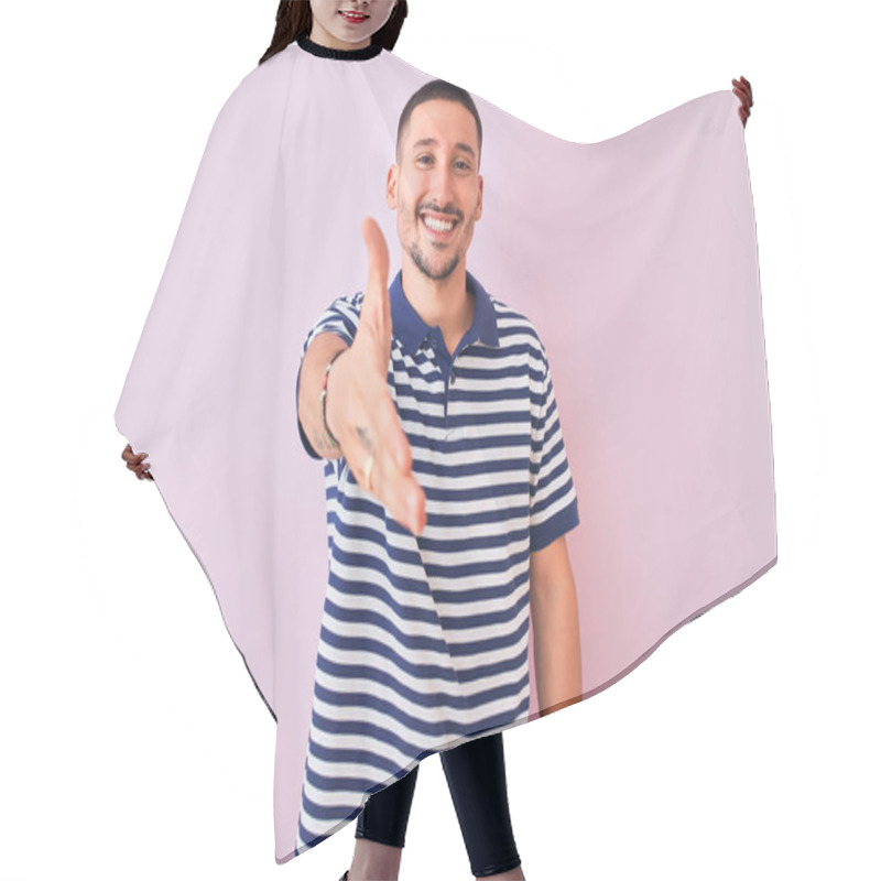 Personality  Young Handsome Man Wearing Nautical Striped T-shirt Over Pink Isolated Background Smiling Friendly Offering Handshake As Greeting And Welcoming. Successful Business. Hair Cutting Cape