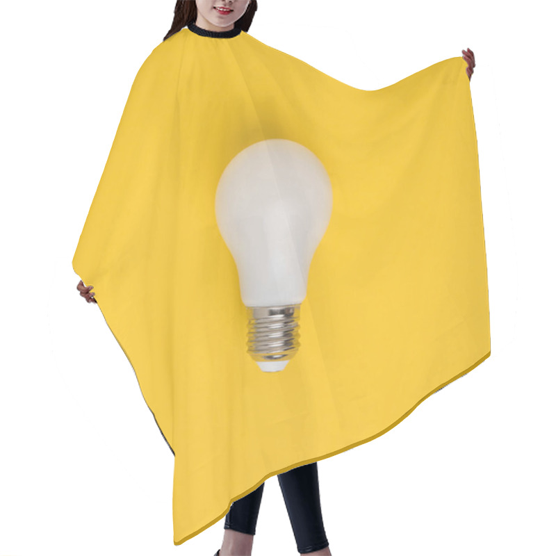 Personality  Close Up View Of White Light Bulb Isolated On Yellow Hair Cutting Cape