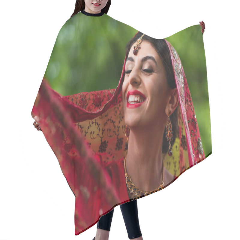 Personality  Positive Indian Bride In Red Sari Adjusting Headscarf With Ornament  Hair Cutting Cape