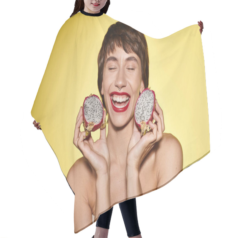 Personality  A Woman Playfully Holds Two Dragon Fruits In Front Of Her Face. Hair Cutting Cape