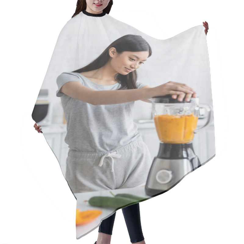 Personality  Young Asian Woman Preparing Fresh Smoothie In Blender Near Blurred Vegetables On Table Hair Cutting Cape