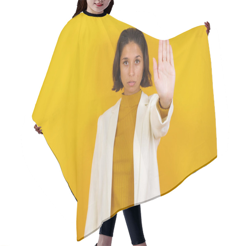 Personality  Young Beautiful Caucasian Woman Doing Stop Gesture With Palm Of The Hand. Warning Expression With Negative And Serious Gesture On The Face Isolated Over Studio Background. Hair Cutting Cape