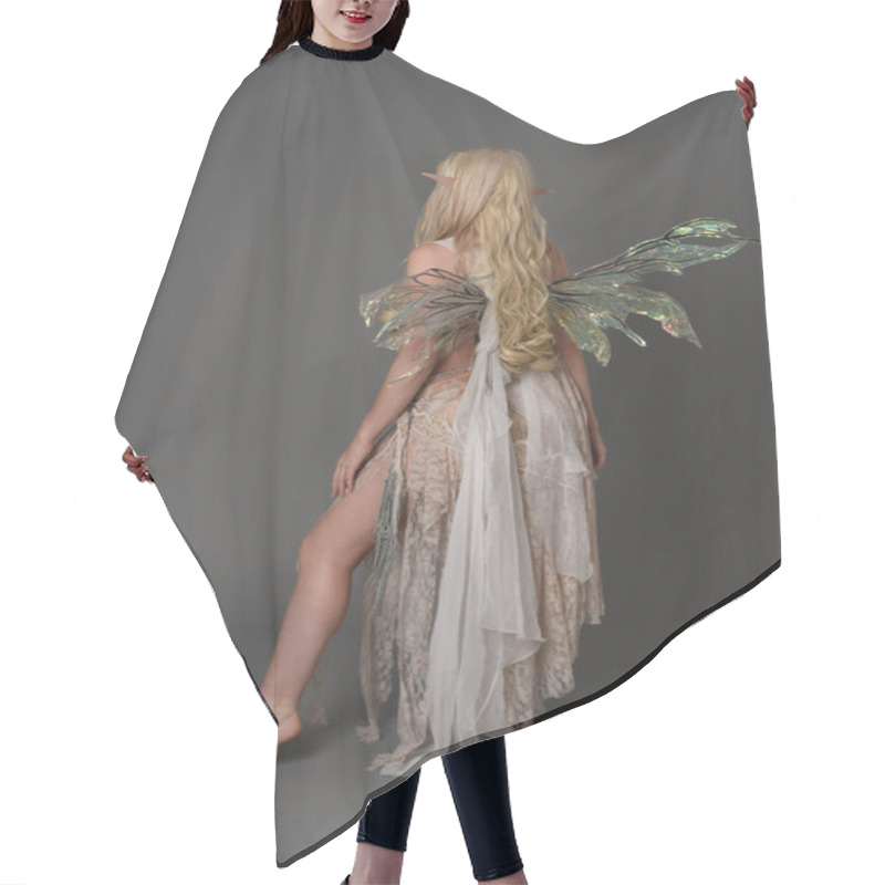 Personality  Full Length Portrait Of Blonder Wearing Fairy Costume, Standing Pose With Back To The Camera.  Grey Studio Background. Hair Cutting Cape