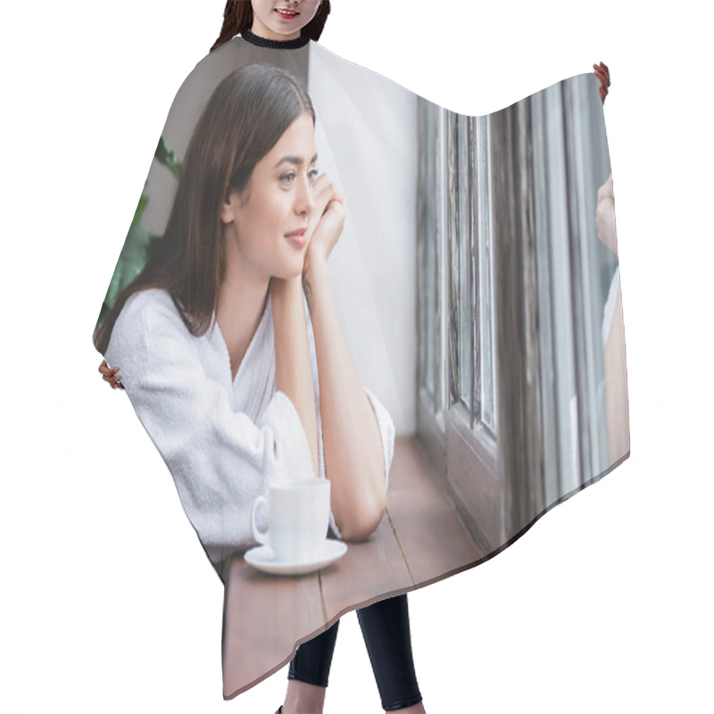 Personality  Smiling Young Adult Woman Sitting With Hands Near Face And Looking Out Window At Home Hair Cutting Cape