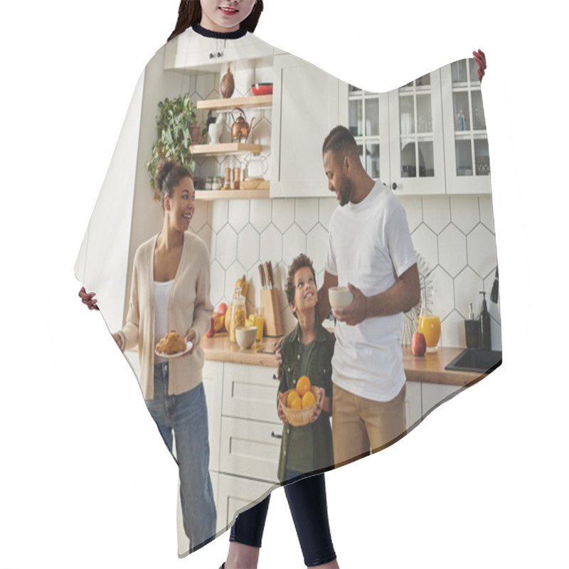 Personality  A Man, Woman, And Child Happily Stand Together In Their Kitchen. Hair Cutting Cape