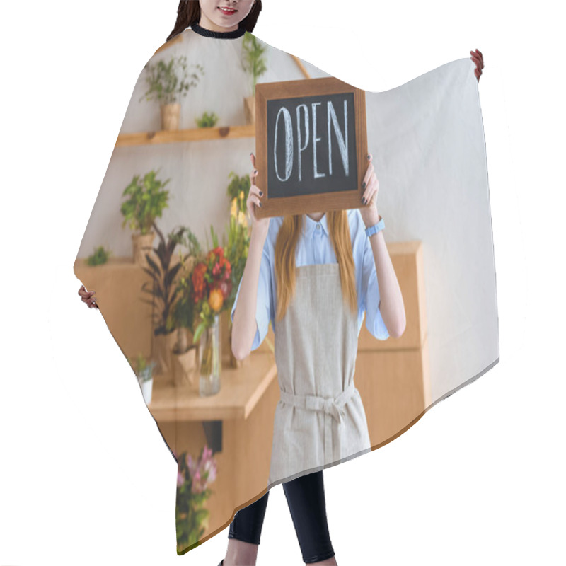 Personality  Young Female Florist In Apron Hiding Face Behind Open Sign In Flower Shop  Hair Cutting Cape