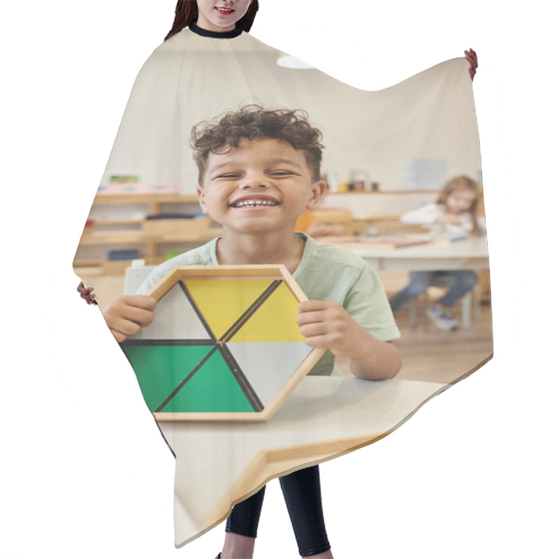 Personality  Happy African American Boy Holding Wooden Game Near Table In Class In Montessori School Hair Cutting Cape