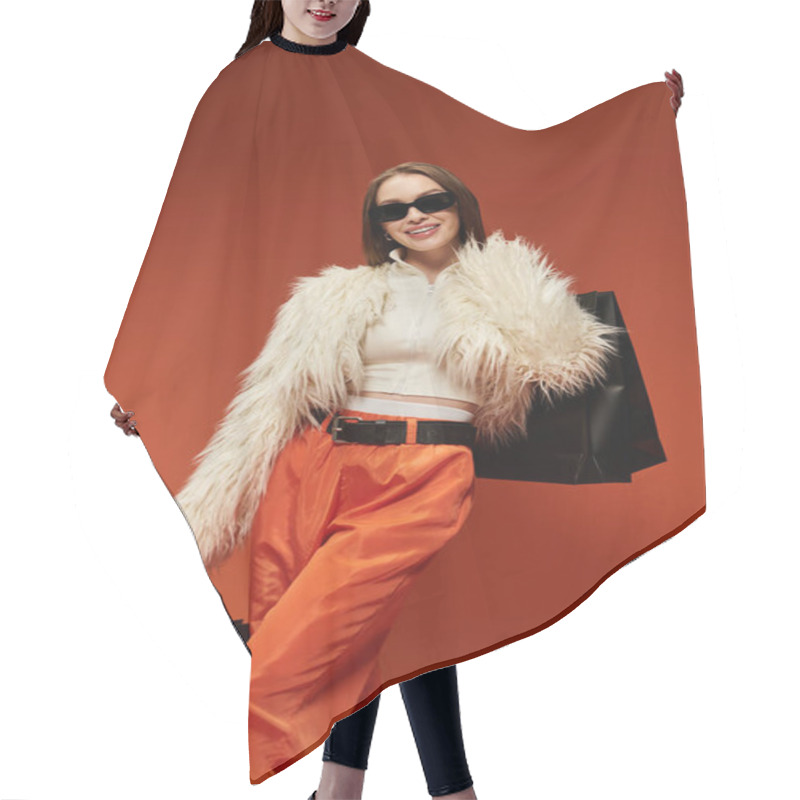 Personality  A Stylish Woman In A Fluffy Coat Poses With Shopping Bags Against A Bright Background. Hair Cutting Cape