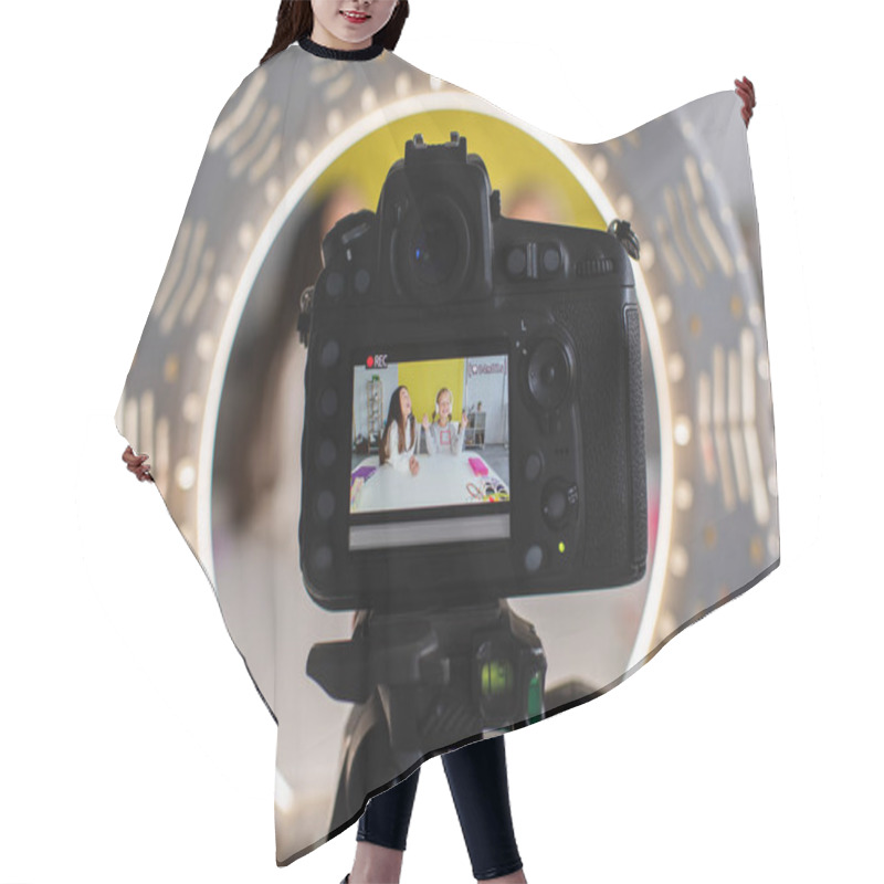 Personality  Selective Focus Of Circle Lamp And Digital Camera With Screen Showing Girls Recording Video Blog  Hair Cutting Cape