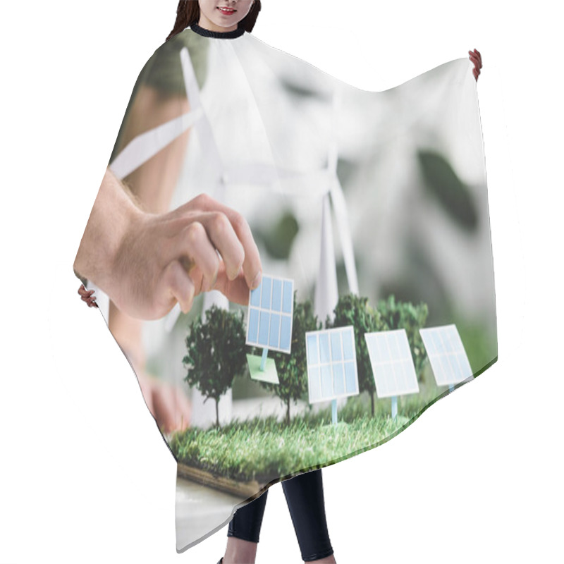 Personality  Cropped View Of Man Putting Solar Panels Models On Grass On Table In Office Hair Cutting Cape