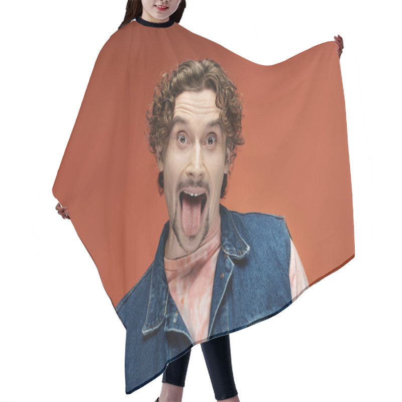 Personality  A Cheerful Man Joyfully Poses, Playfully Sticking Out His Tongue. Hair Cutting Cape