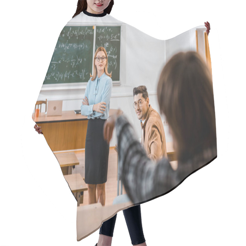 Personality  Selective Focus Of Female Teacher Explaining Lesson Material While Male Student Looking At Classmate Hair Cutting Cape