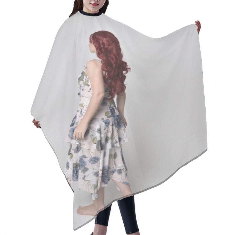 Personality  Portrait Of A Beautiful Woman With Red Hair Wearing  A  Flowing Floral Gown.  Full Length Standing Pose, Isolated Against A Studio Background Hair Cutting Cape