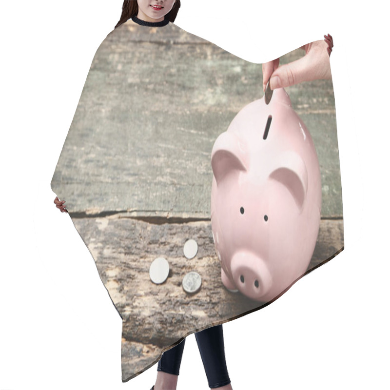 Personality  Female Hand Putting Coin Into Pink Piggy Bank On Wooden Table Hair Cutting Cape