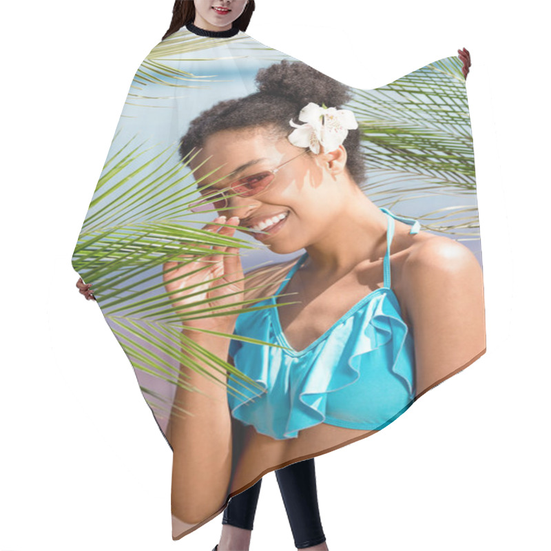 Personality  Smiling African American Woman In Sunglasses With Flower In Hair Near Palm Leaves In Front Of Sea Hair Cutting Cape