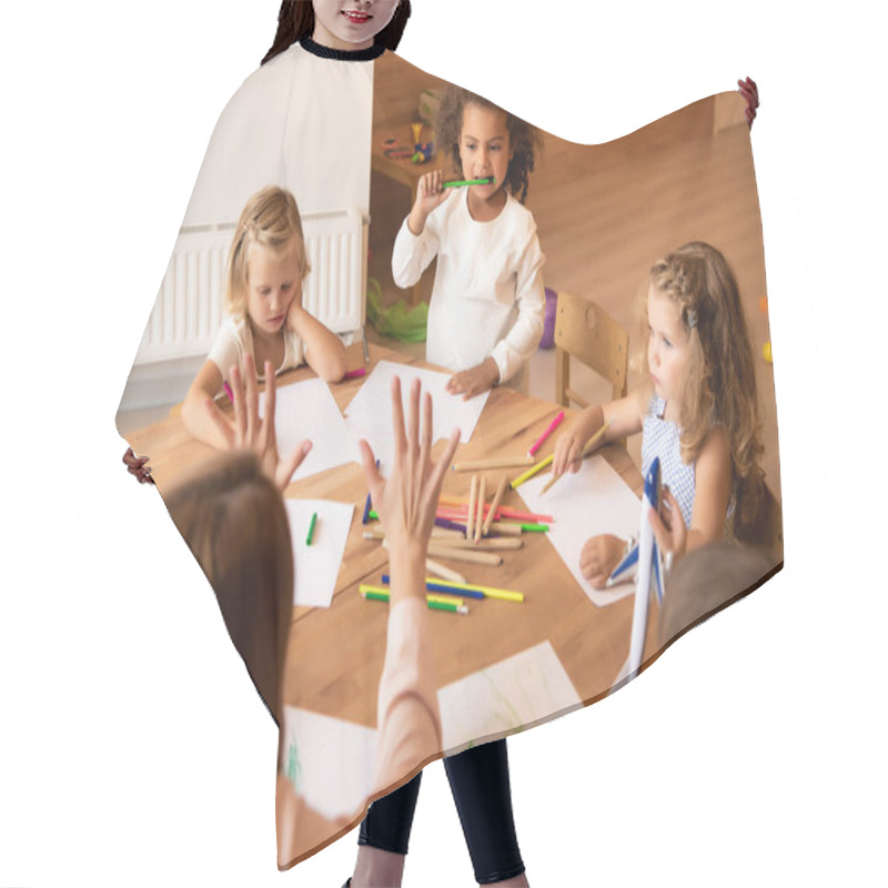 Personality  Back View Of Educator Teaching Multicultural Kids Counting And Showing Number With Fingers In Kindergarten Hair Cutting Cape