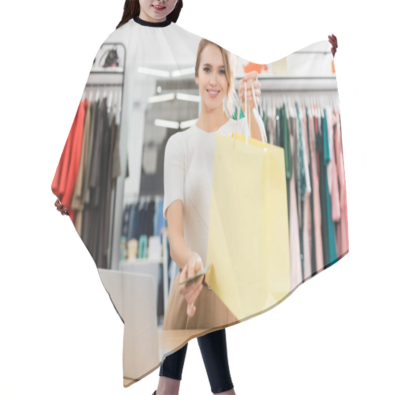 Personality  Cheerful Seller Holding Shopping Bag And Money In Showroom  Hair Cutting Cape