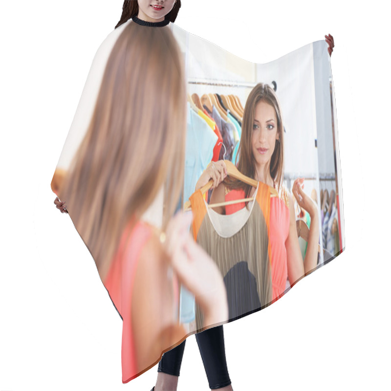 Personality  Beautiful Girl Trying Dress Near Mirror On Room Background Hair Cutting Cape