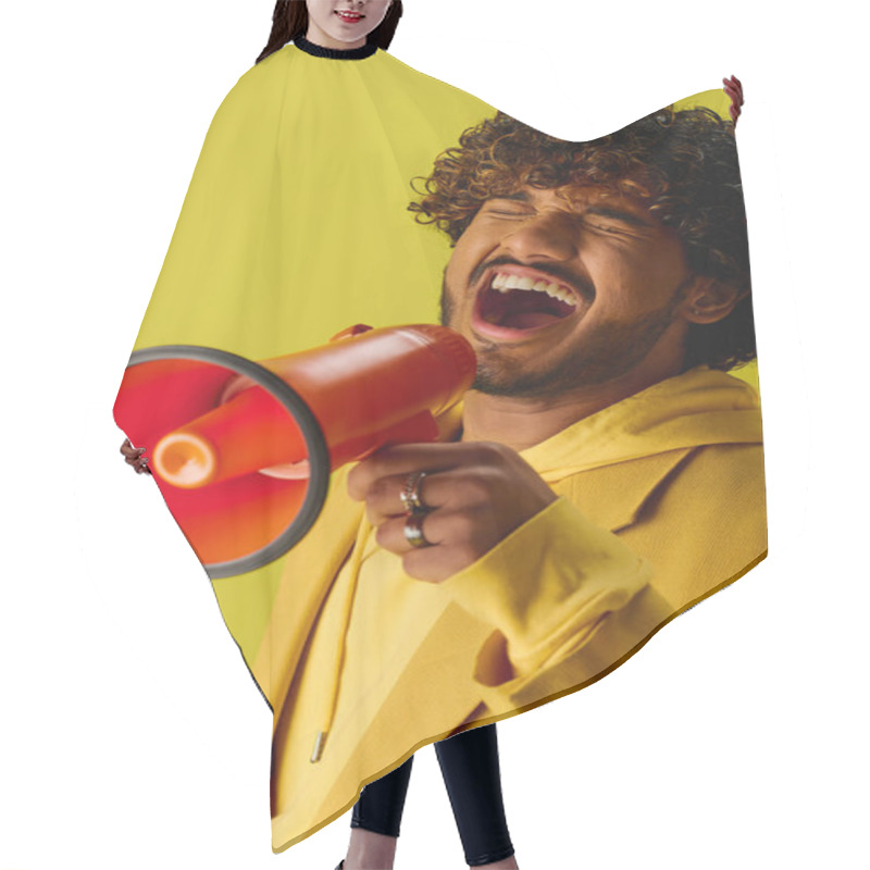 Personality  Handsome Young Indian Man In Bold Yellow Suit Commands Attention With Red And Black Megaphone. Hair Cutting Cape