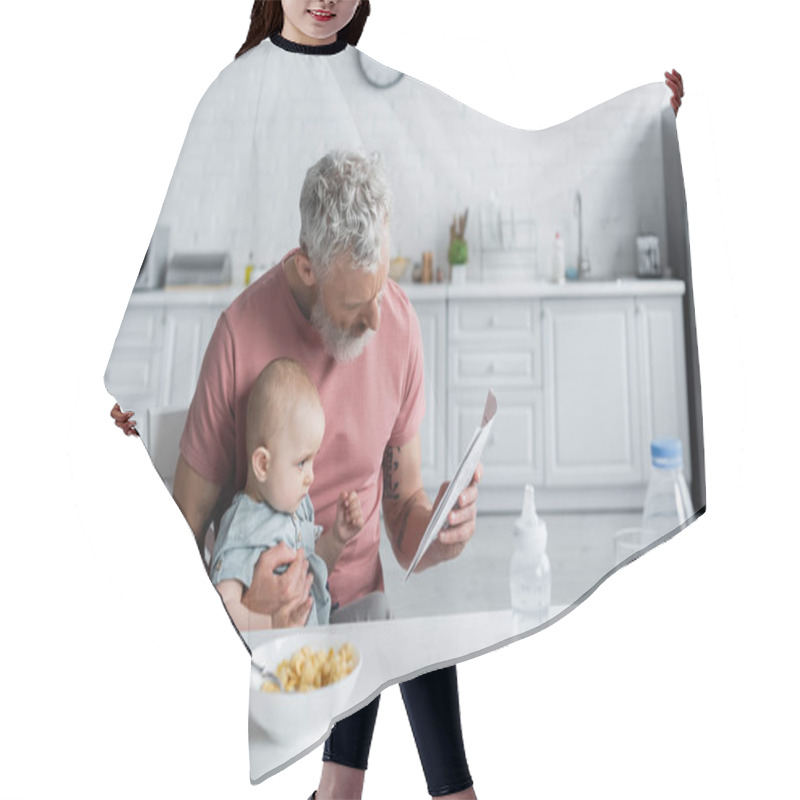 Personality  Mature Man Reading News Near Baby Daughter And Breakfast In Kitchen  Hair Cutting Cape