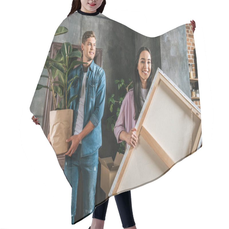 Personality  Happy Young Woman Carrying Canvas And Her Boyfriend Holding Ficus Plant While Moving Into New Home Hair Cutting Cape