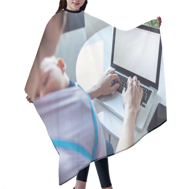 Personality  Shot Of Pretty Young Mother With Her Baby In Sling Working With Laptop At Home. Hair Cutting Cape