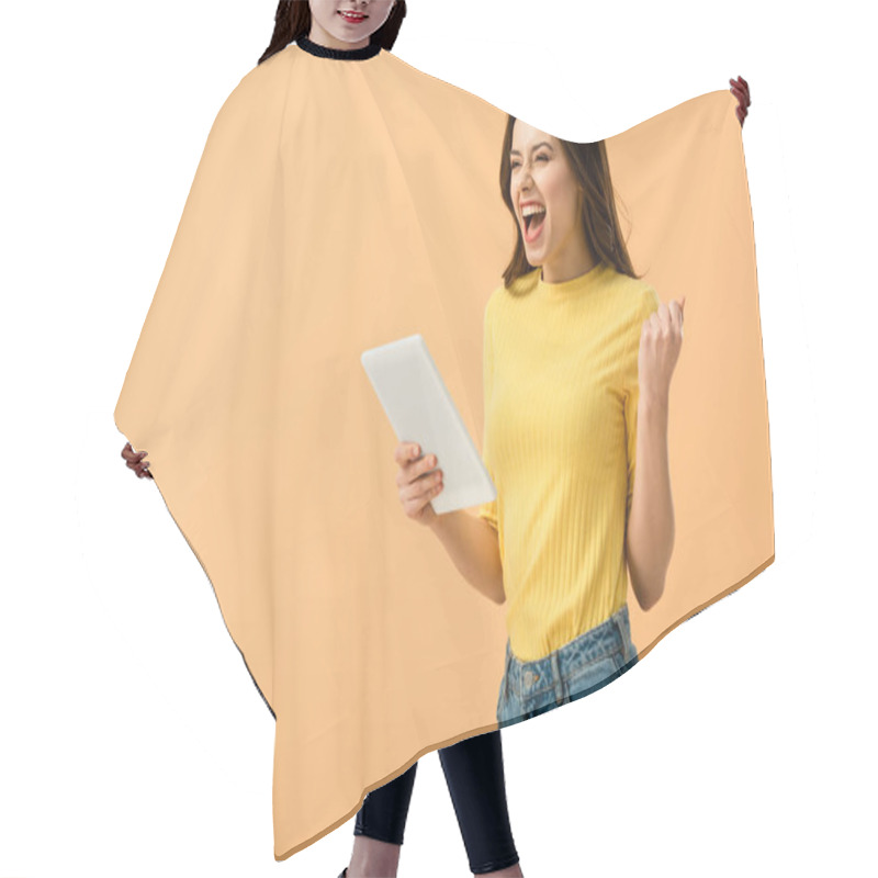 Personality  Excited Brunette Girl Holding Digital Tablet And Laughing Isolated On Orange Hair Cutting Cape