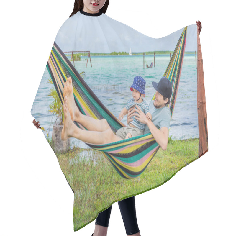 Personality  Father With His Toddler Son Lying In A Hammock Against The Backdrop Of Turquoise Waters Of Bacalar Lake, Mexico. Peaceful Tropical Travel Destination Concept. Hair Cutting Cape