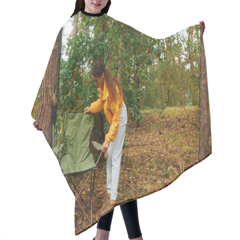 Personality  A Young African American Woman Sets Up Her Chair In A Vibrant Autumn Forest Filled With Colorful Foliage. Hair Cutting Cape