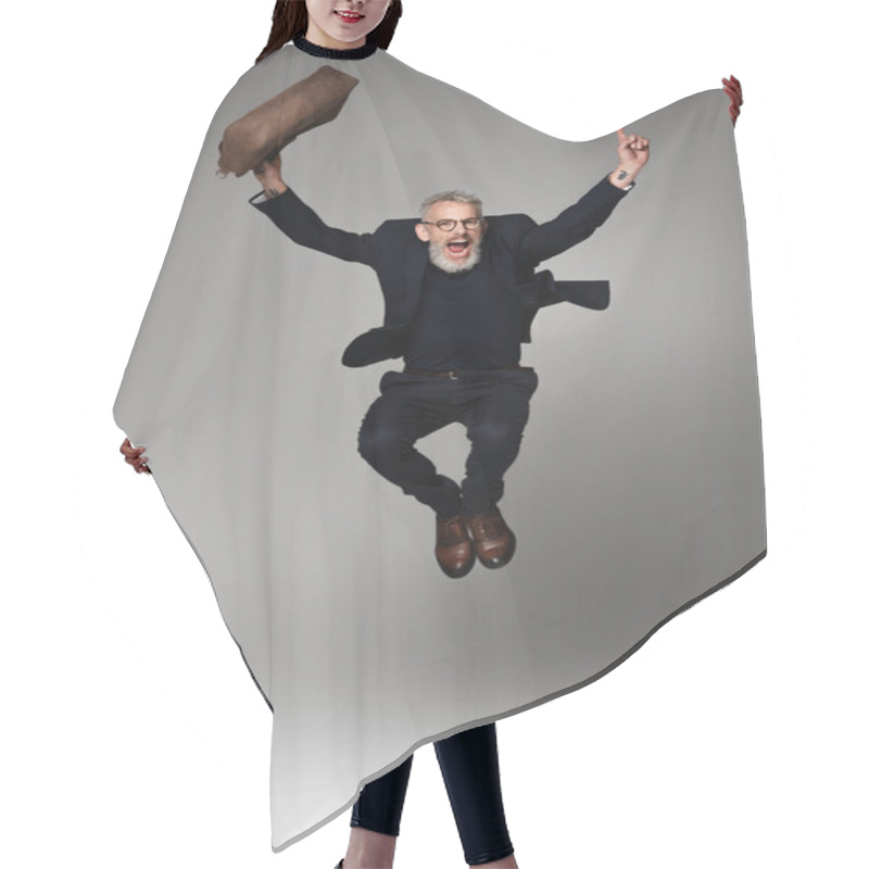 Personality  Full Length Of Amazed Man With Grey Hair Holding Leather Bag While Levitating On Grey Hair Cutting Cape