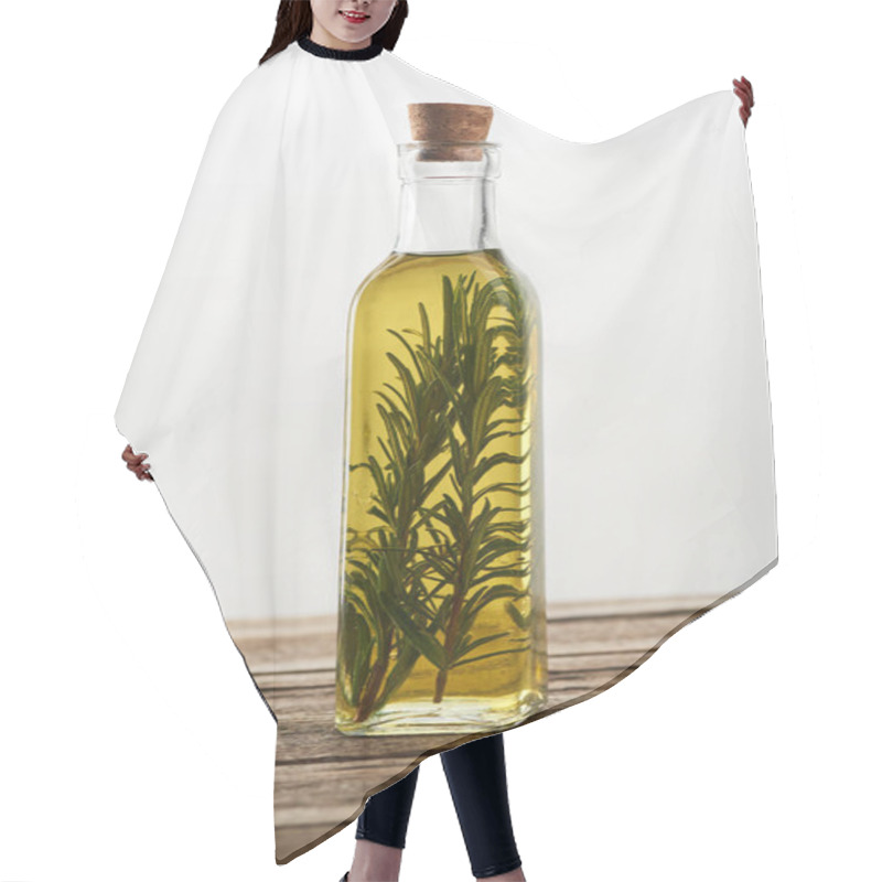 Personality  Bottle Of Flavored Oil With Rosemary Branches On Wooden Surface Hair Cutting Cape