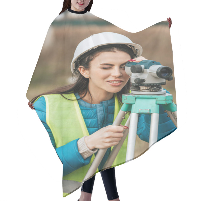 Personality  Attractive Smiling Surveyor Working With Digital Level Hair Cutting Cape