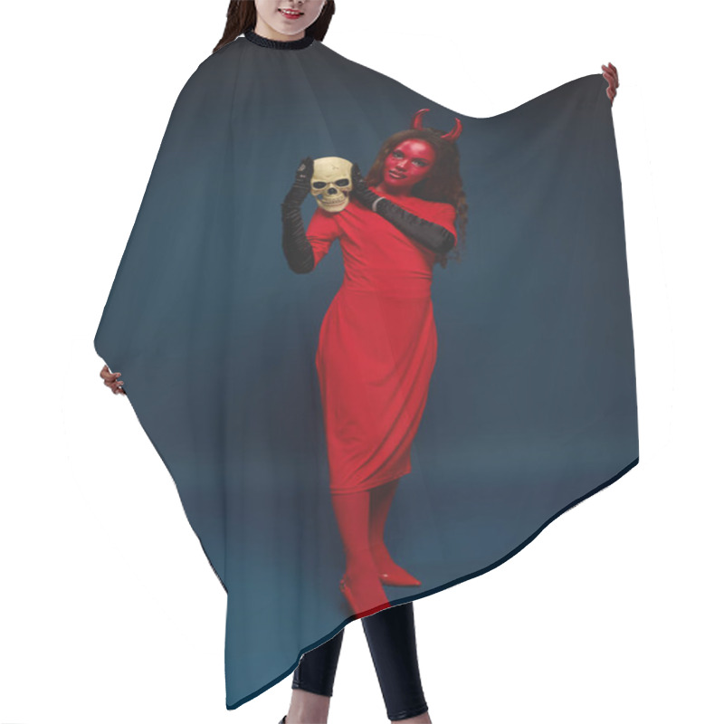 Personality  A Stunning Woman Dressed As A Devil Gracefully Poses With A Skull, Embracing Halloween Spirit. Hair Cutting Cape