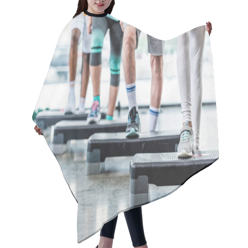 Personality  Cropped Image Of Sportspeople Doing Exercise On Step Platforms At Gym Hair Cutting Cape