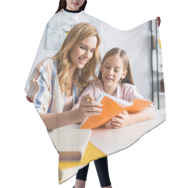 Personality  Selective Focus Of Smiling Mother And Kid Looking At Notebook Near Laptop And Books On Table  Hair Cutting Cape