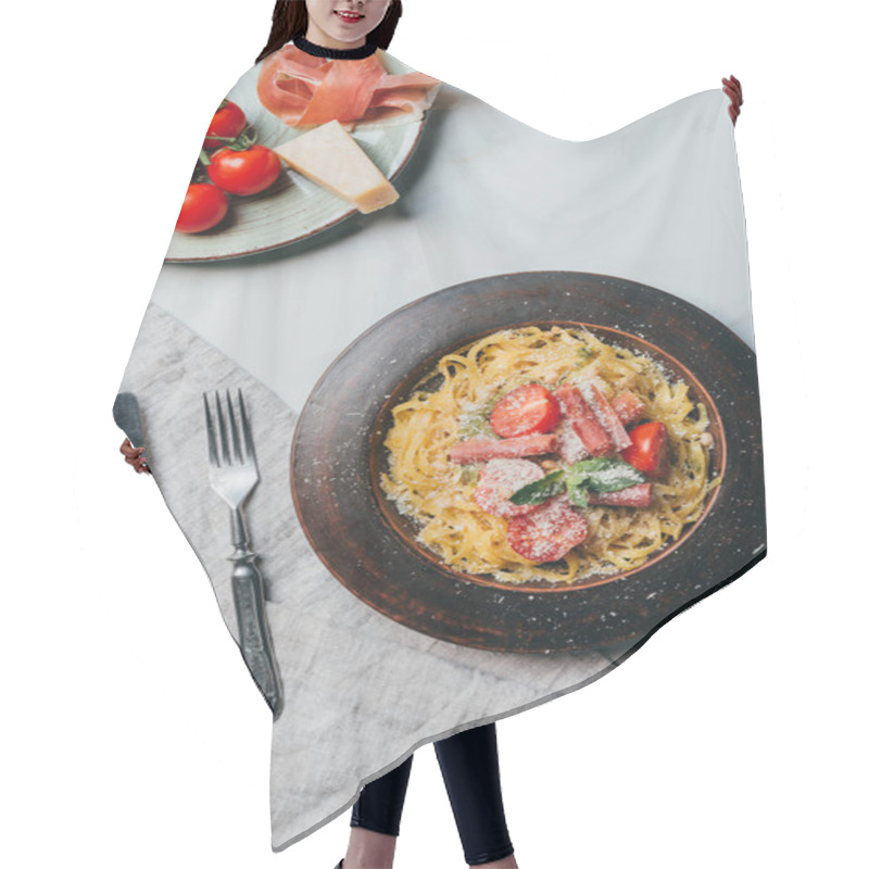 Personality  Elevated View Of Plates With Pasta And Jamon, Parmesan And Cherry Tomtatoes On Marble Table With Kitchen Towel, Fork And Knife  Hair Cutting Cape