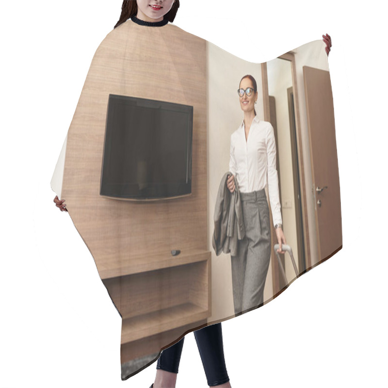 Personality  A Young Woman Walks Into A Chic Hotel Room Holding A Suitcase, Exuding Confidence And Style. Hair Cutting Cape