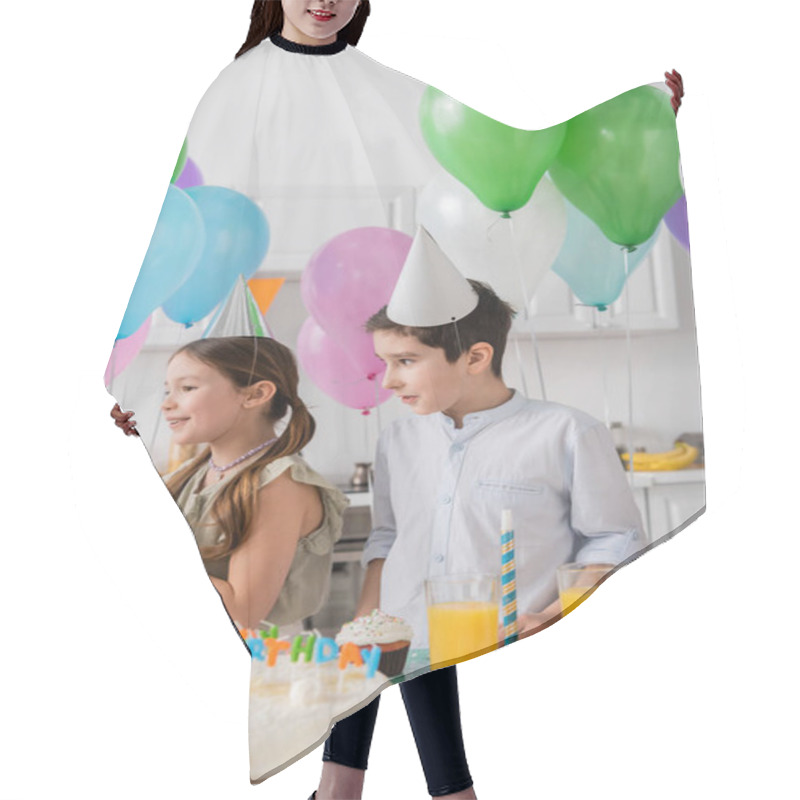 Personality  Cheerful Girl And Boy Standing Near Birthday Cake With Candles Next To Balloons  Hair Cutting Cape