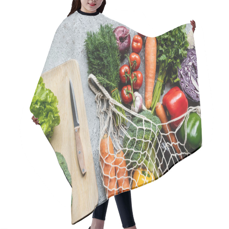 Personality  Top View Of Fresh Ripe Vegetables In String Bag Near Cutting Board With Knife On Grey Concrete Surface Hair Cutting Cape