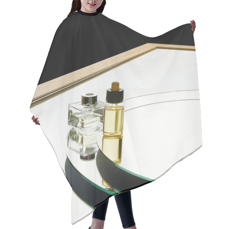 Personality  High Angle View Of Aromatic Perfume Bottle And Serum Bottle On Mirror Surface Isolated On Black Hair Cutting Cape