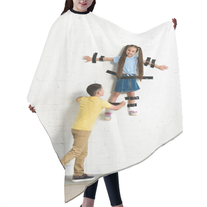 Personality  Brother Gluing Sister To Wall With Black Tape At Home Hair Cutting Cape