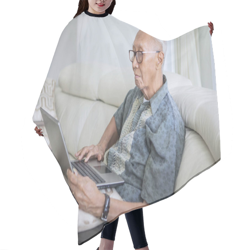 Personality  Elderly Man Using A Laptop At Home Hair Cutting Cape